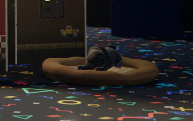 Close-up: Pam the black pug asleep on a round dog bed on the confetti carpet